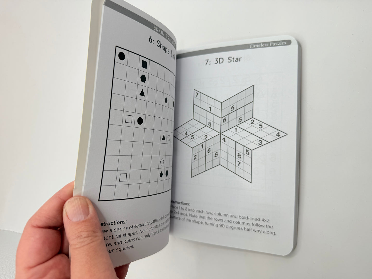 Timeless puzzles: brain trainer by publications international - print books printed media