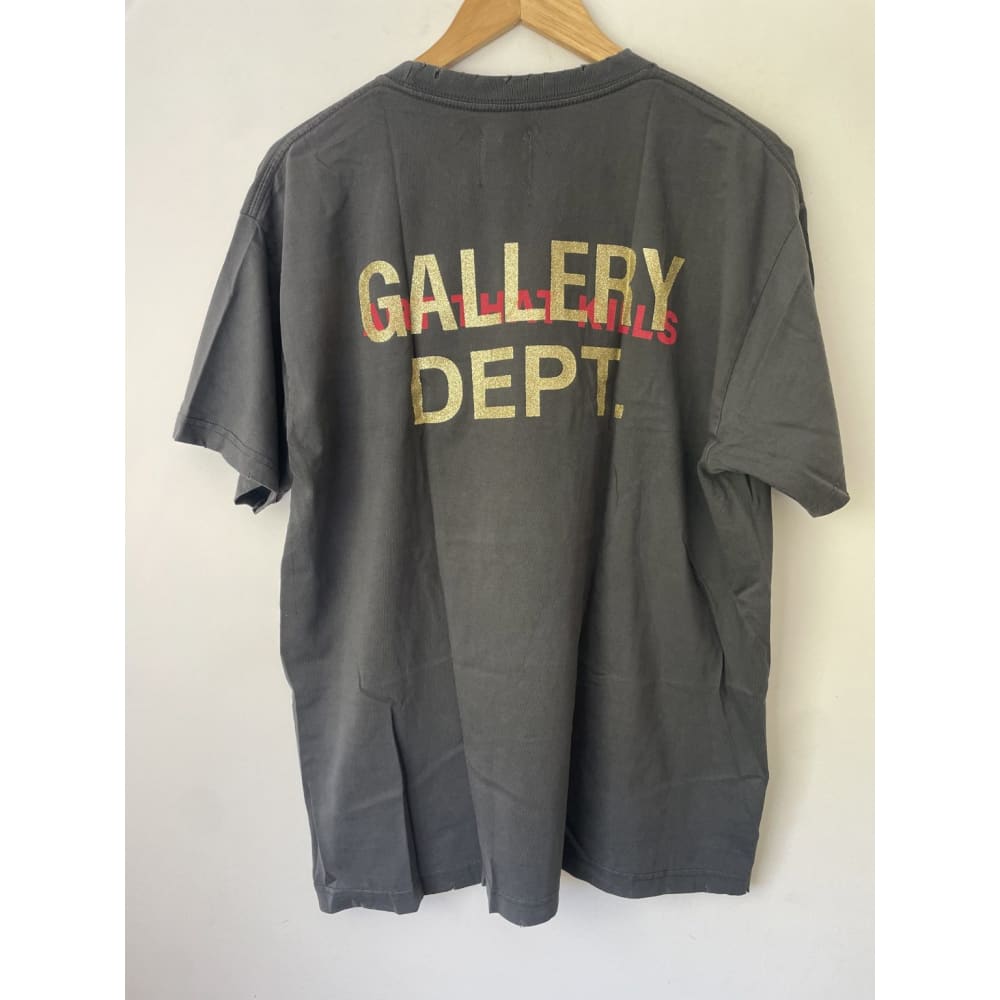 Back of gray Gallery Dept. T-shirt hanging on a wooden hanger.