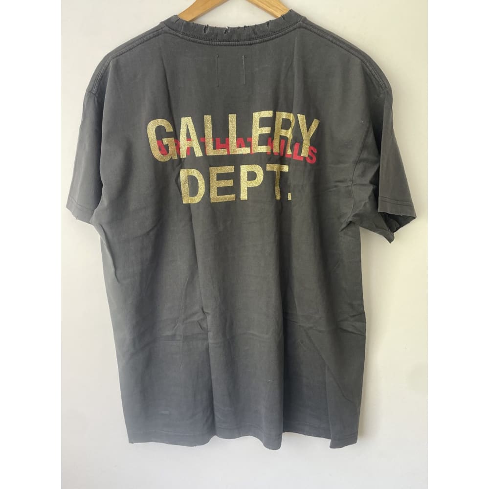 Back of a gray t-shirt with gold and red lettering.