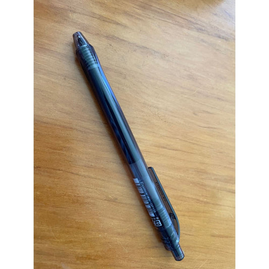 Black pen on a wooden surface.