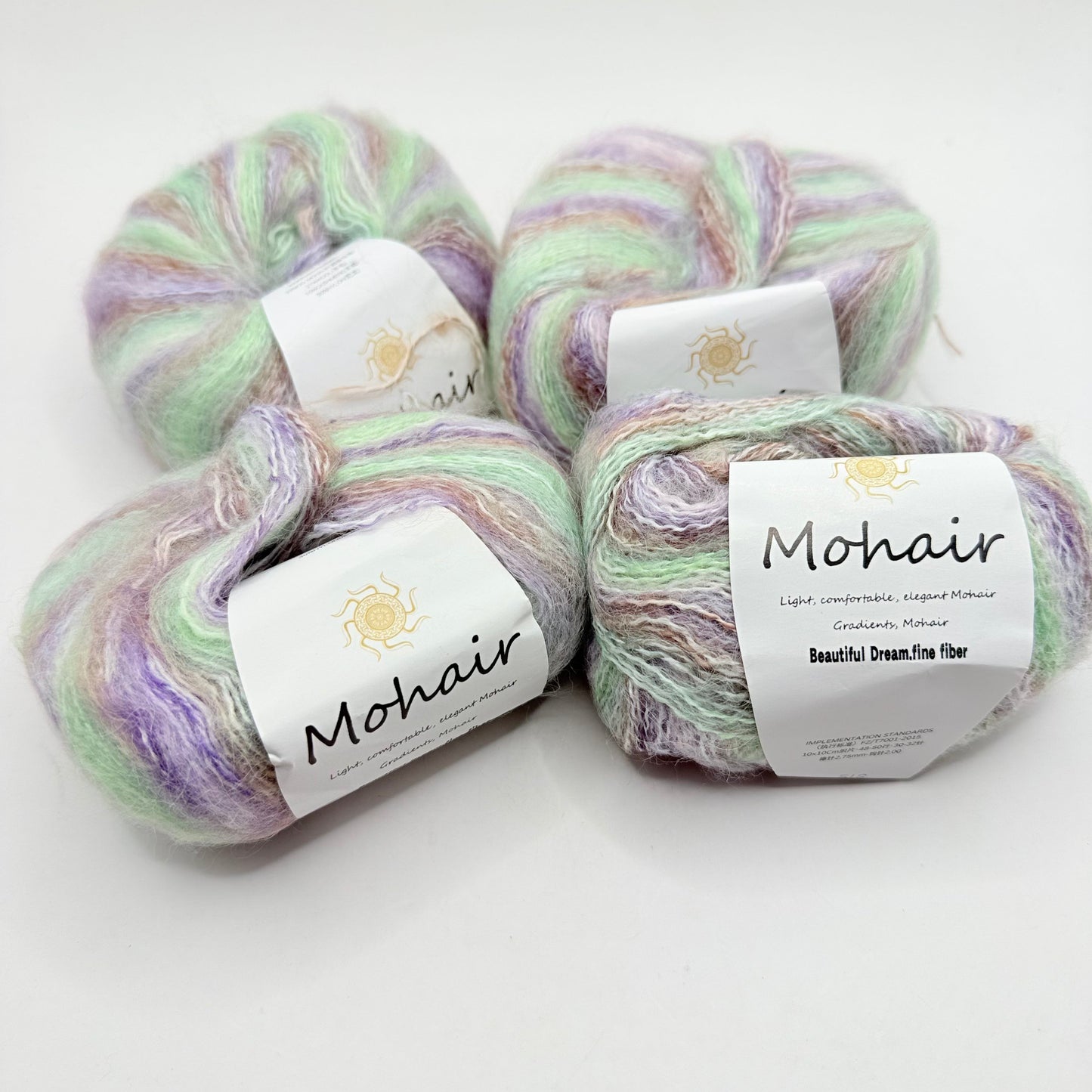 Four skeins of soft, pastel-colored mohair yarn.