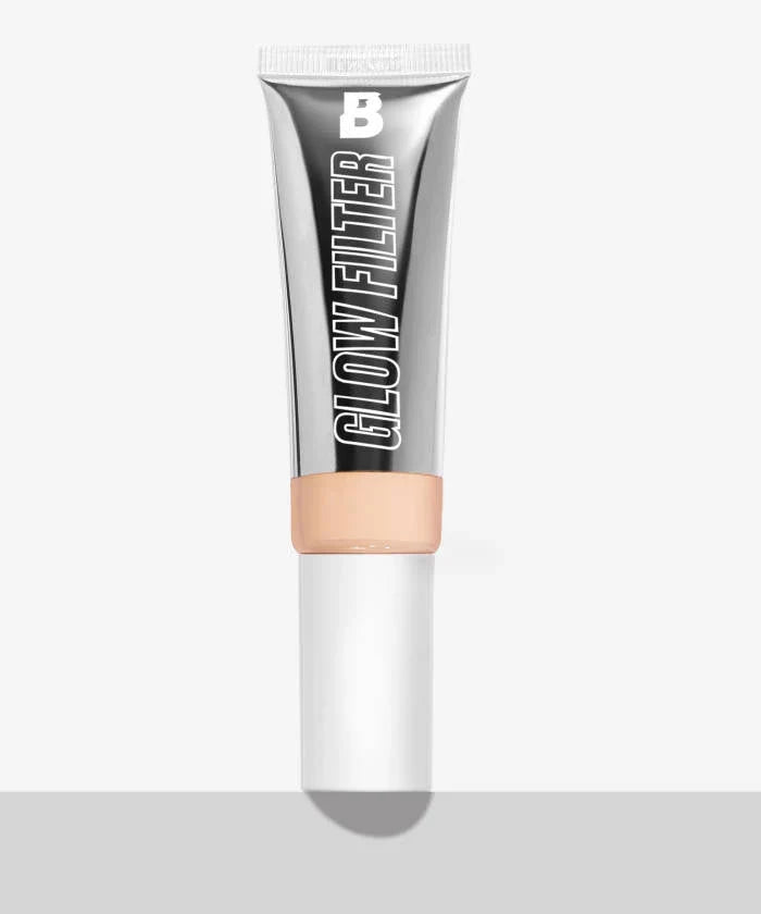 A tube of light-toned liquid foundation with a metallic silver finish and a white cap.