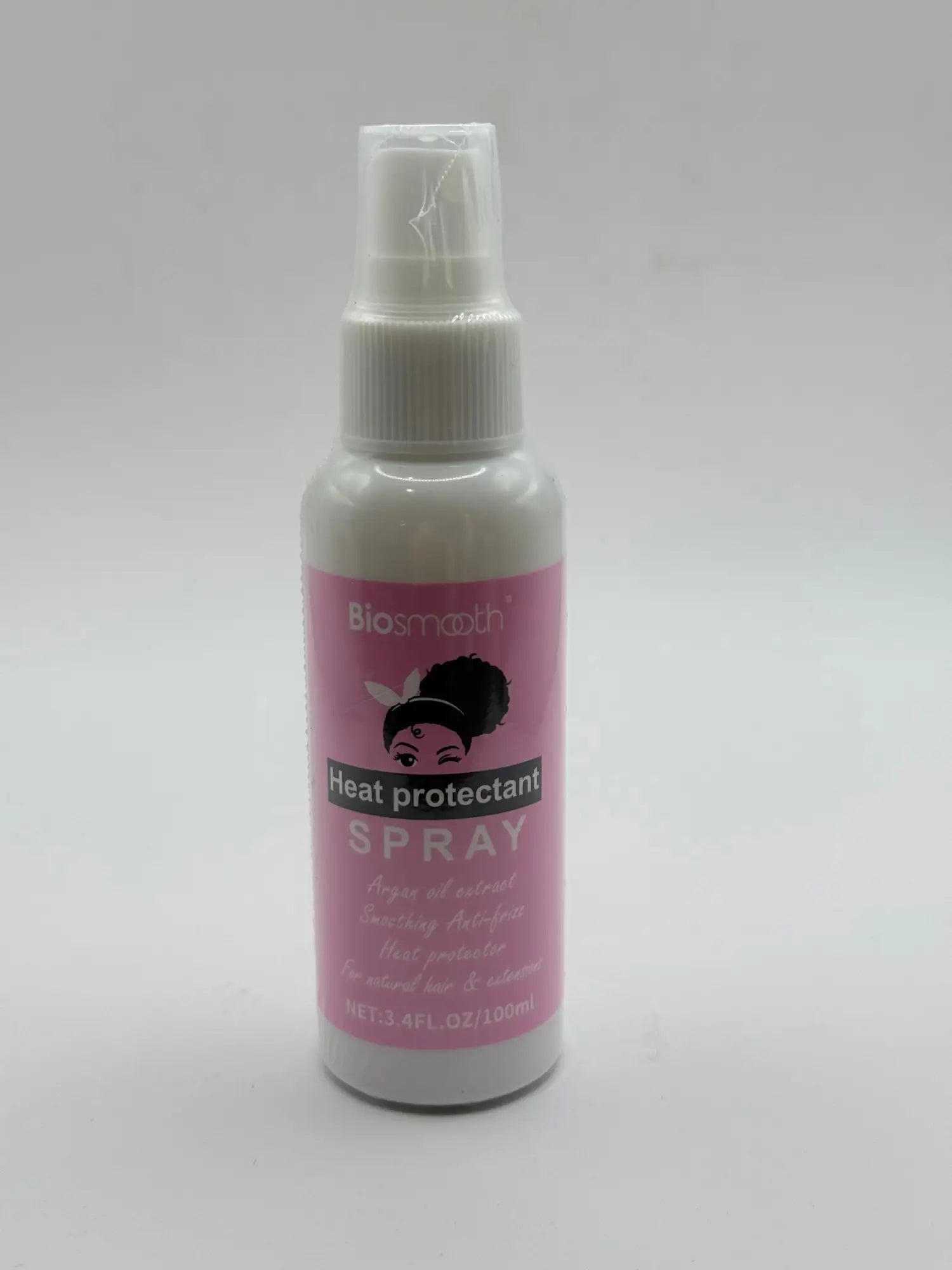 A white spray bottle with a pink label for heat protectant hair spray.