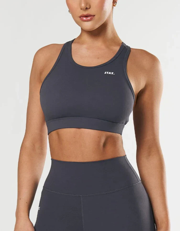 A dark gray racerback sports bra with matching high-waisted leggings.