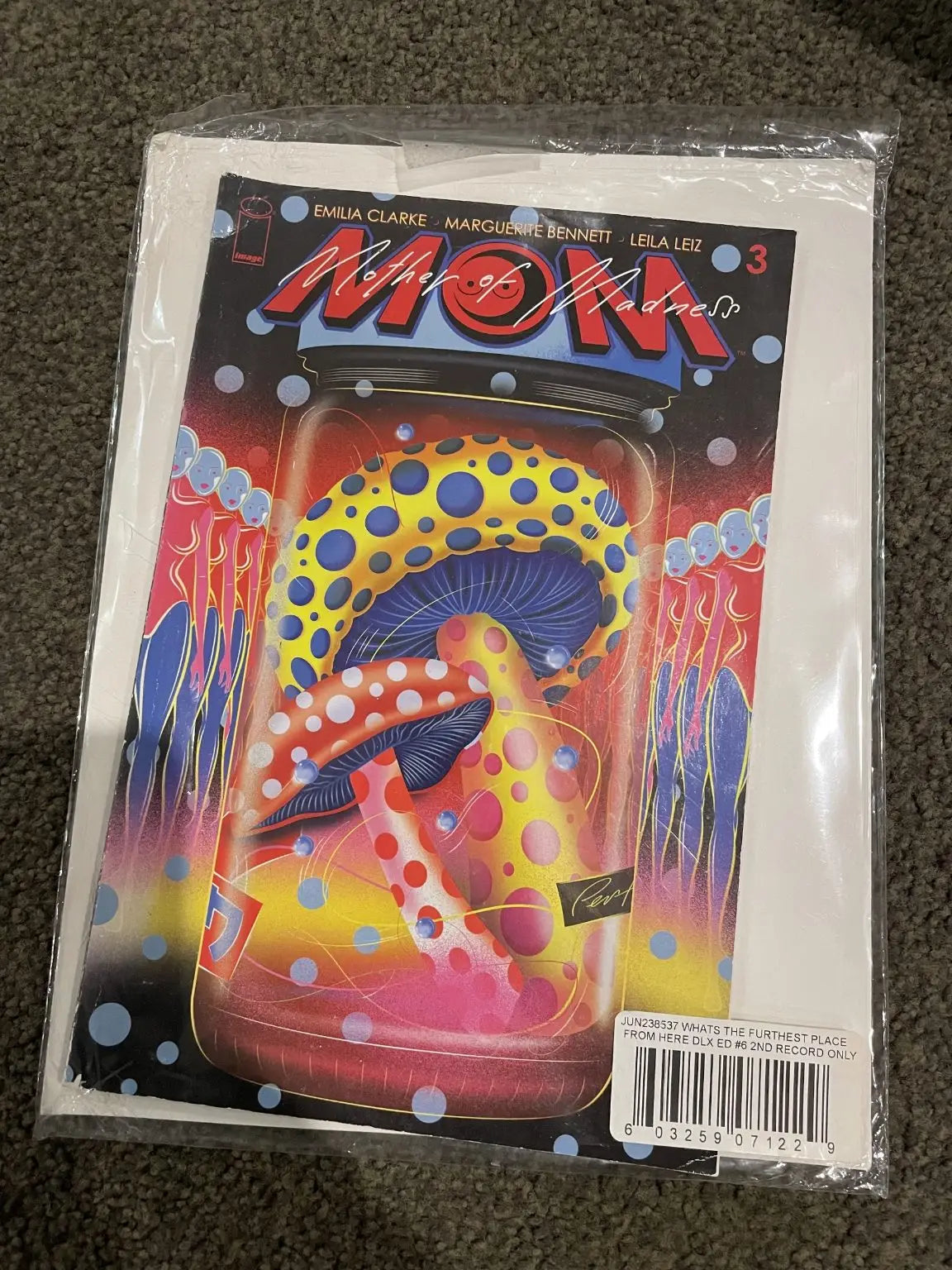 A comic book titled ’Mother of Madness #3’’ featuring colorful, spotted mushrooms in a jar on its cover.