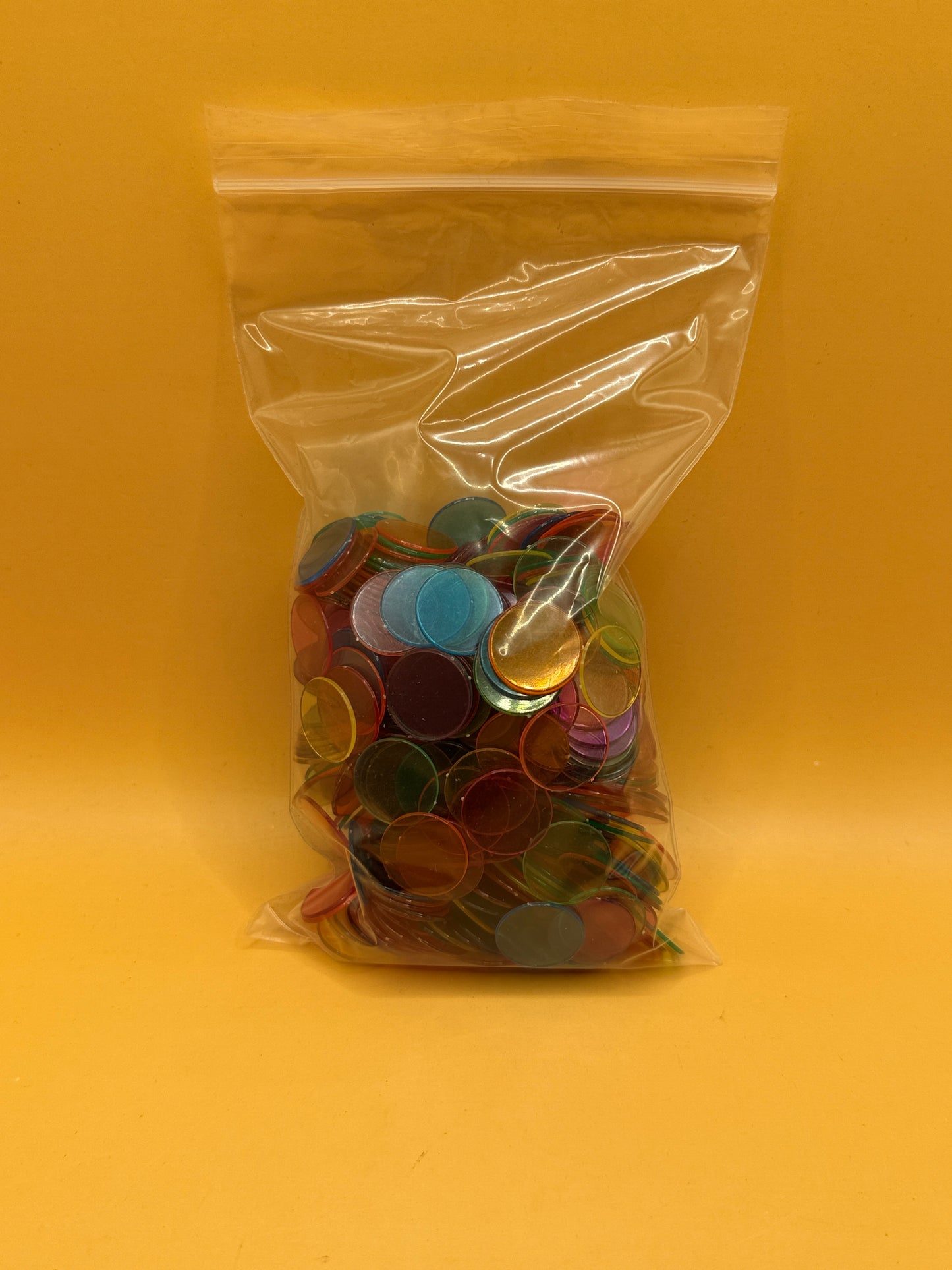 Assorted translucent plastic counting chips in mixed colours