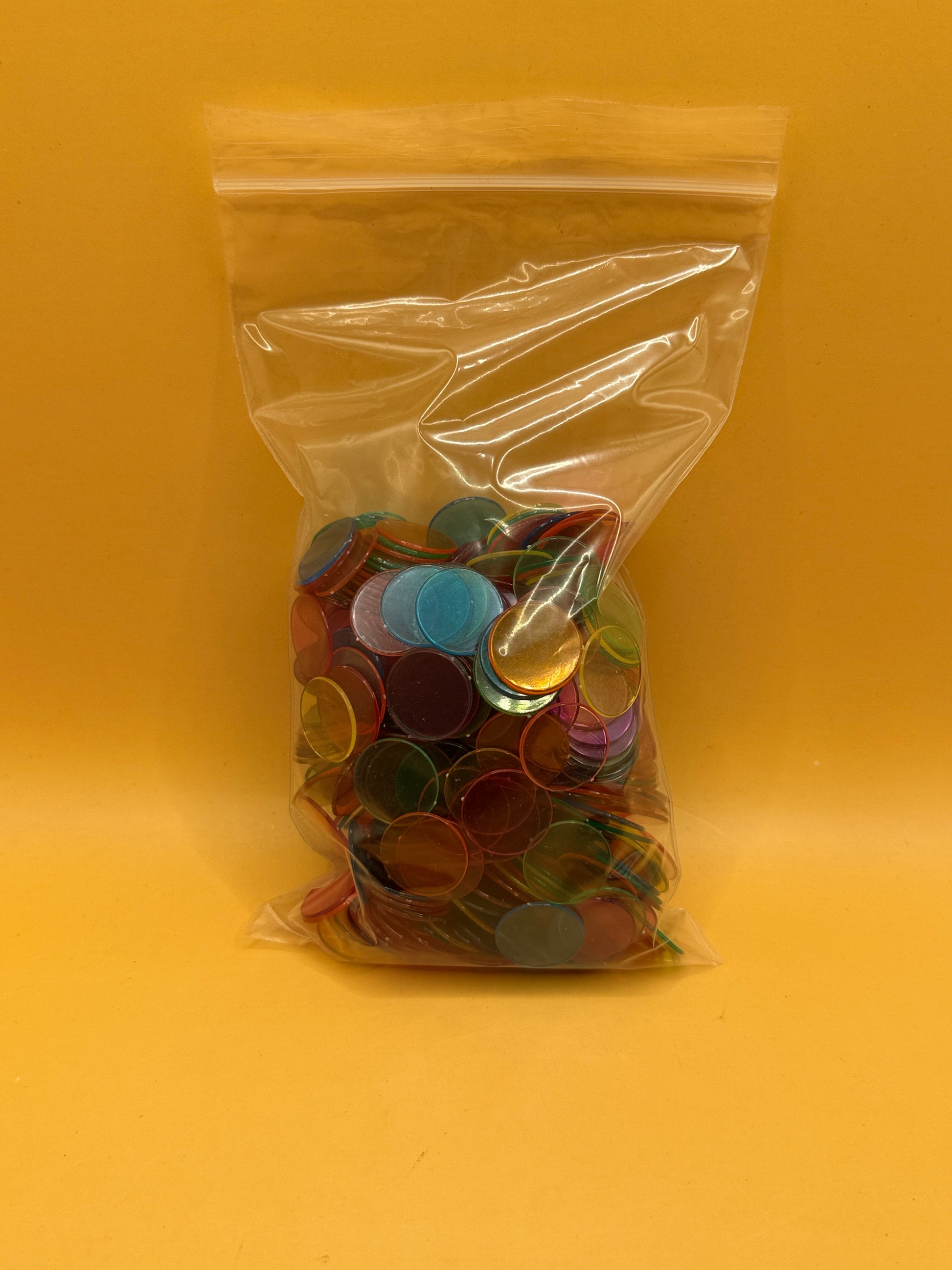 Assorted translucent plastic counting chips in mixed colours
