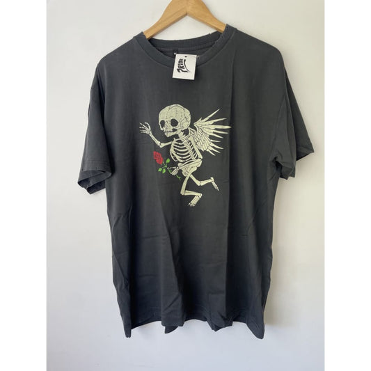 Black t-shirt with skeleton angel graphic hanging on wooden hanger against white background.