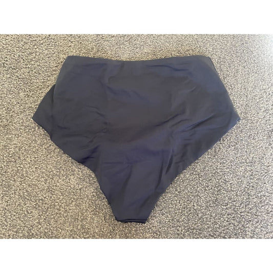 Dark blue high-waisted bathing suit bottom on carpet.
