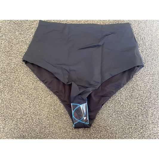 High-waisted black underwear on gray carpet.