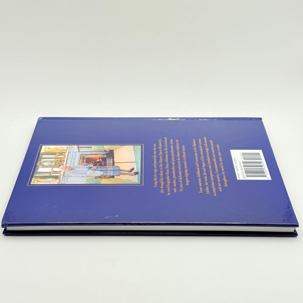 A dark blue hardcover book with an illustrated cover and a barcode.