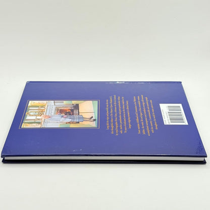 A dark blue hardcover book with an illustrated cover and a barcode.