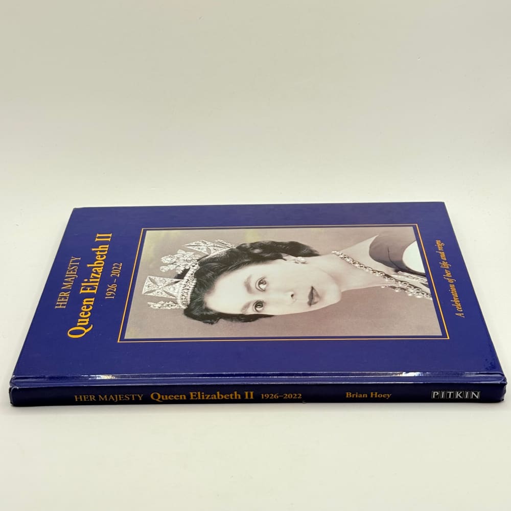 A commemorative book about Queen Elizabeth II with a sepia-toned portrait on the cover.