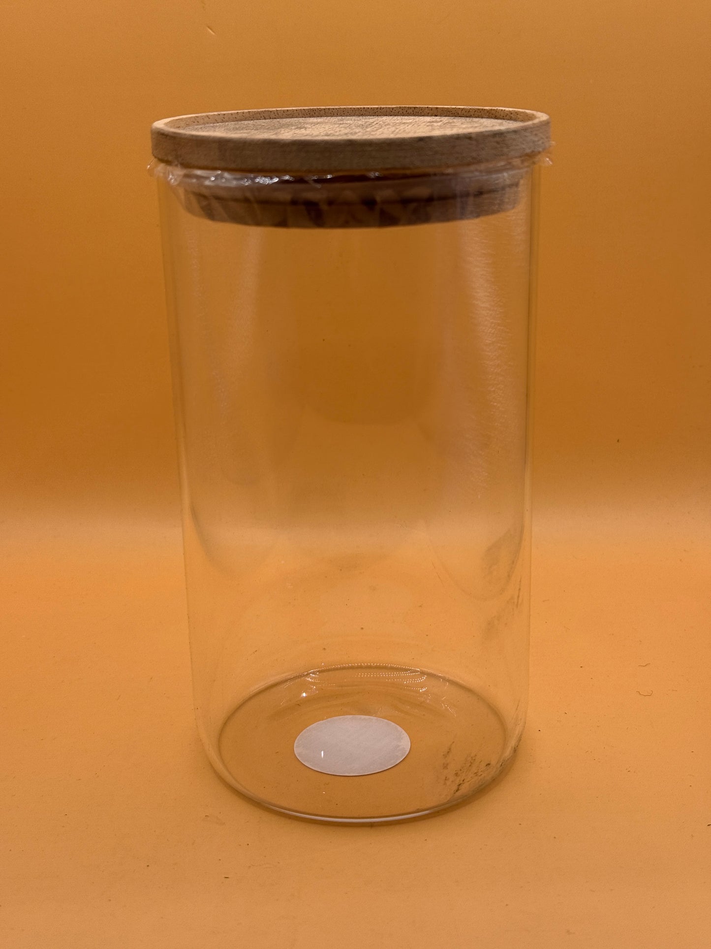 Large clear glass canister with natural finish lid