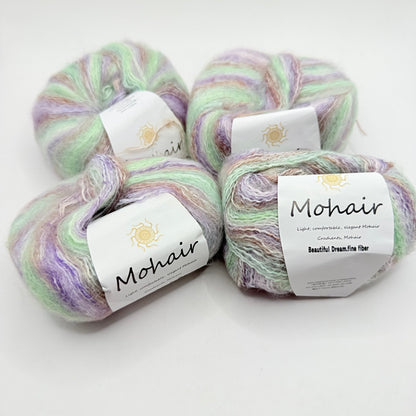 Four skeins of soft, pastel-colored mohair yarn.
