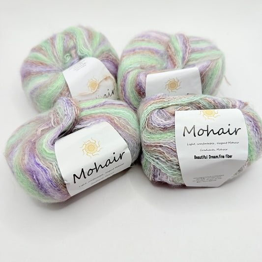 Four skeins of soft, pastel-colored mohair yarn.